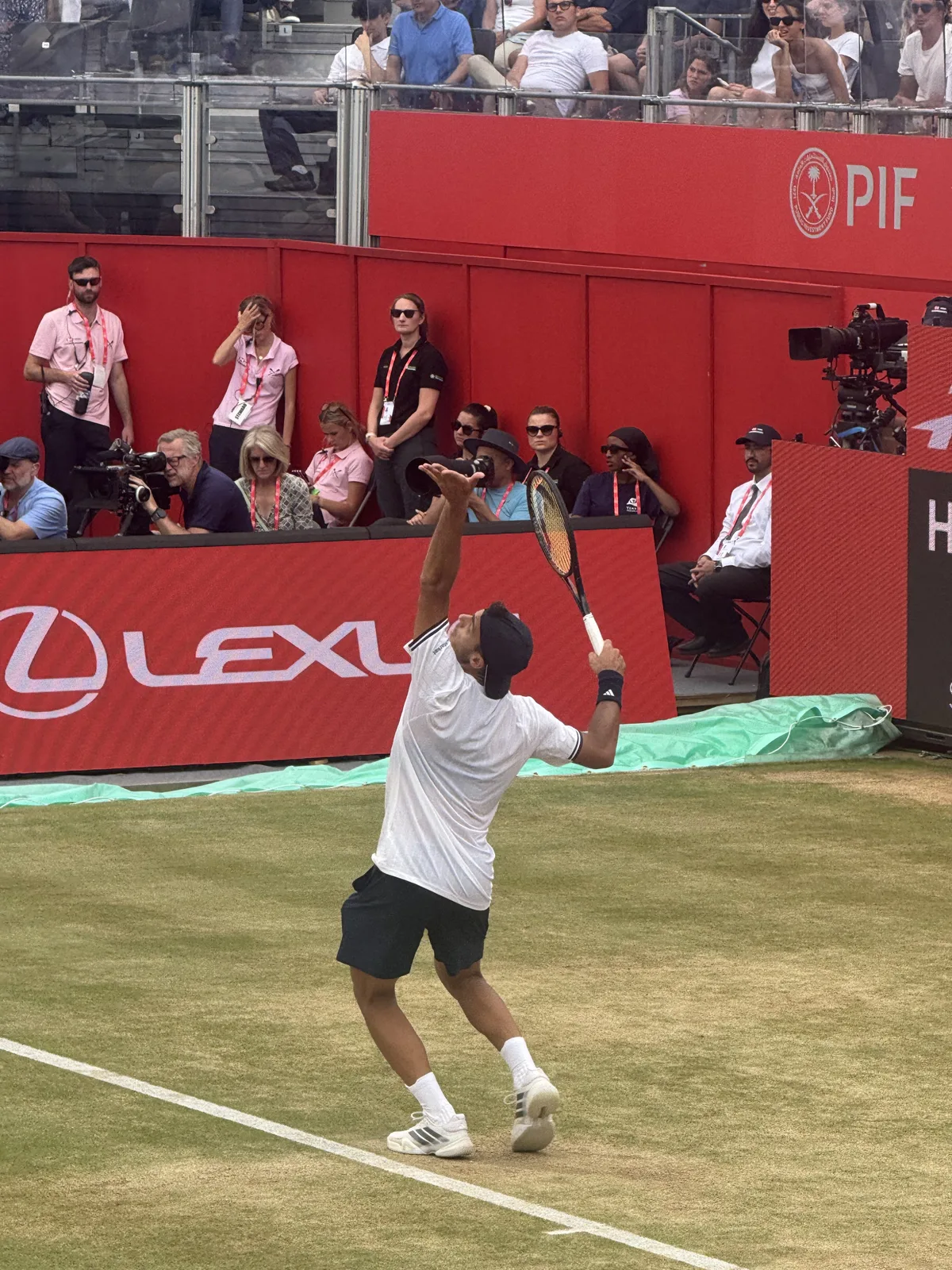Francisco Cerundolo mid-follow-through on grass at Queen's Club, 2026 HSBC Championships.